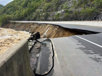 An interstate is washed out alongside a river.