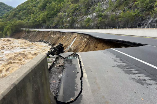 An interstate is washed out alongside a river.