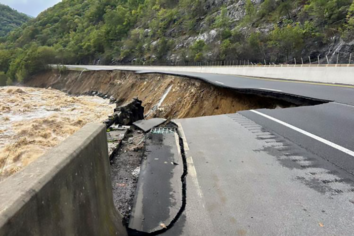 An interstate is washed out alongside a river.