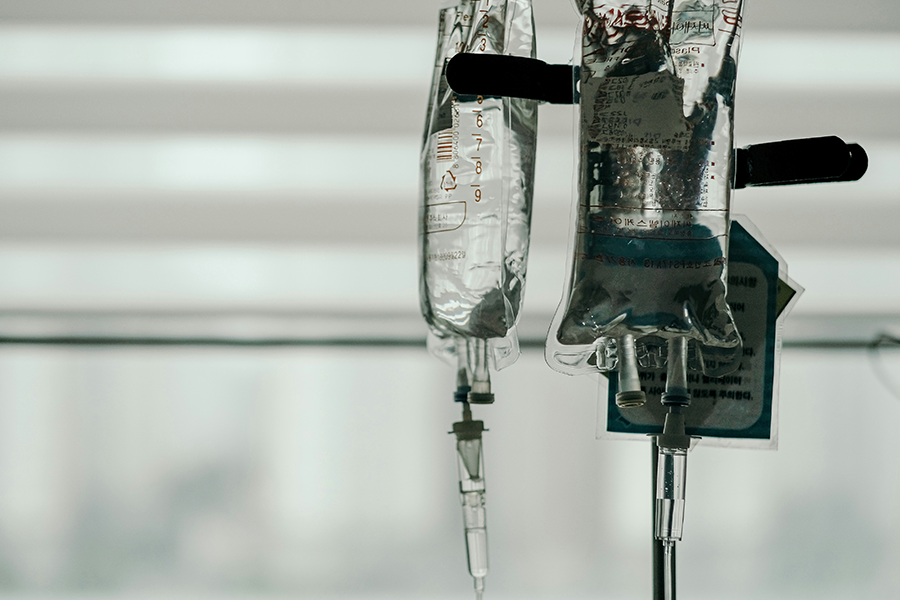 IV bags hang from a pole in a hospital