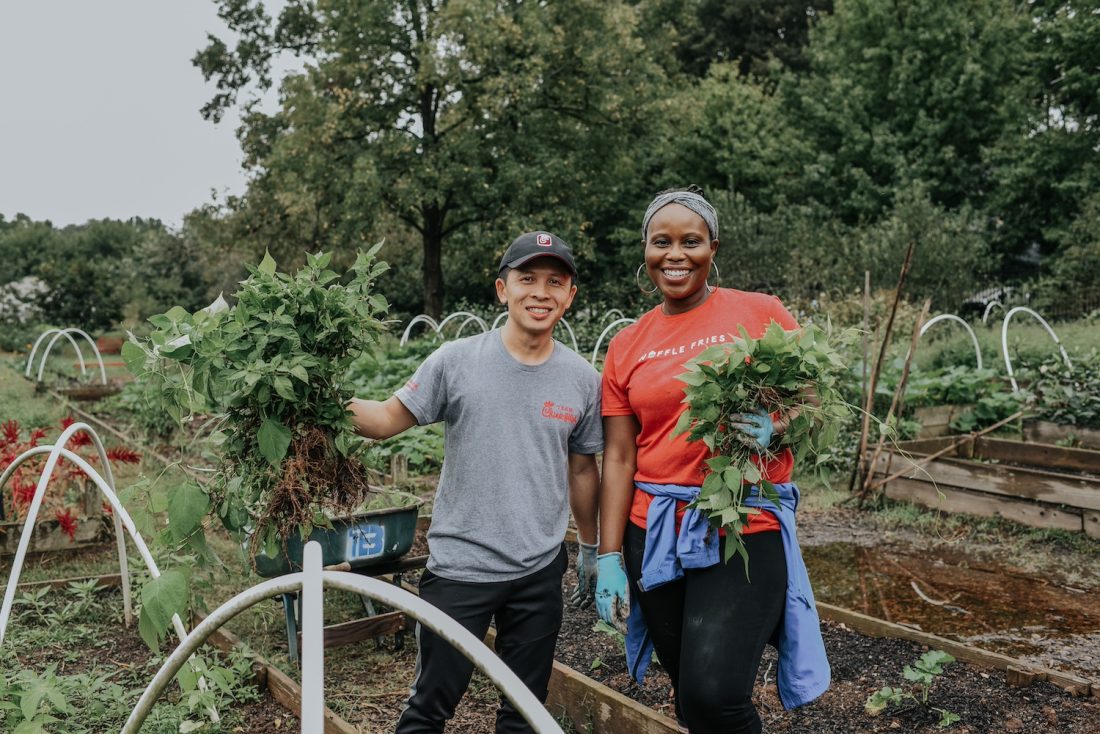 Woman and man standing on a farm.