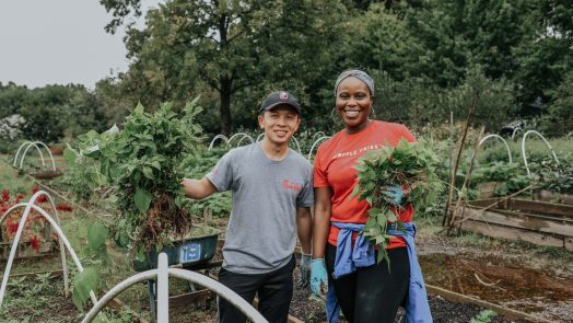 Woman and man standing on a farm.