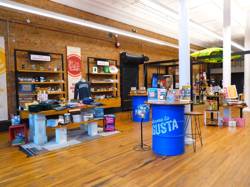 Inside a local small business with several displays showcasing apparel and other items for sale.