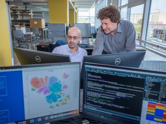 Two men in science lab at computers