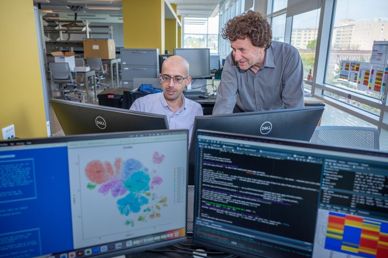 Two men in science lab at computers