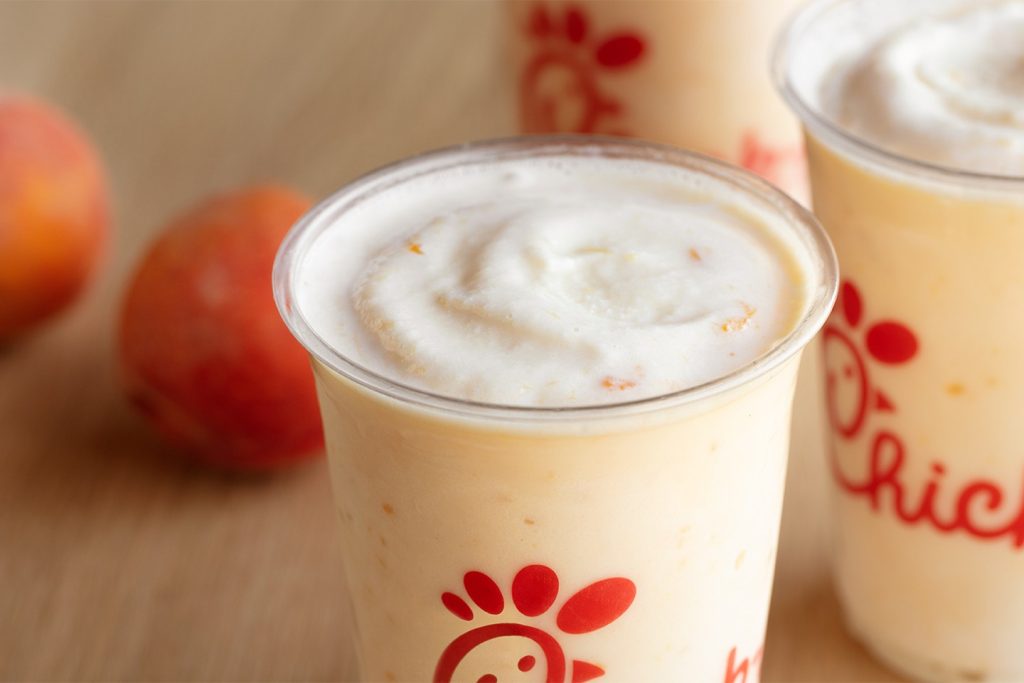 Peach milkshake in a clear Chick-fil-A cup