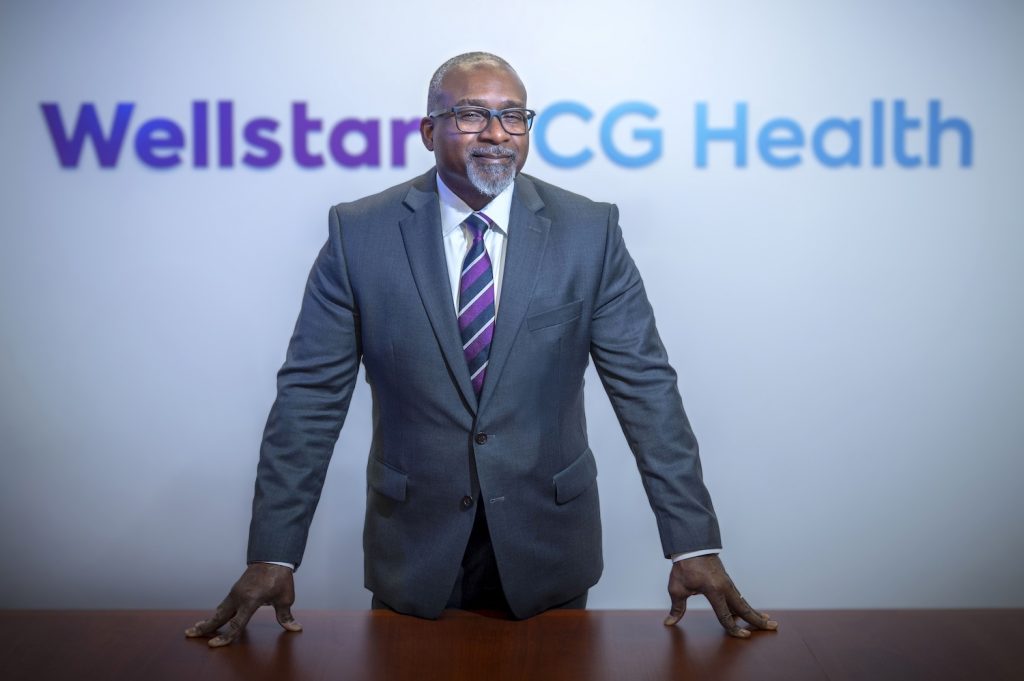 Man standing in front of sign for Wellstar MCG Heath.