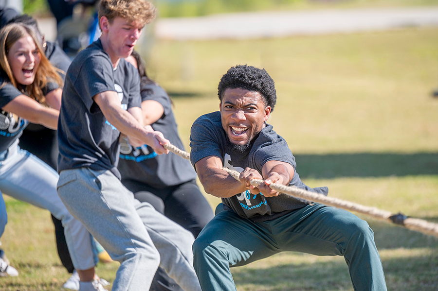 College students competing in a tug-a-war contest.