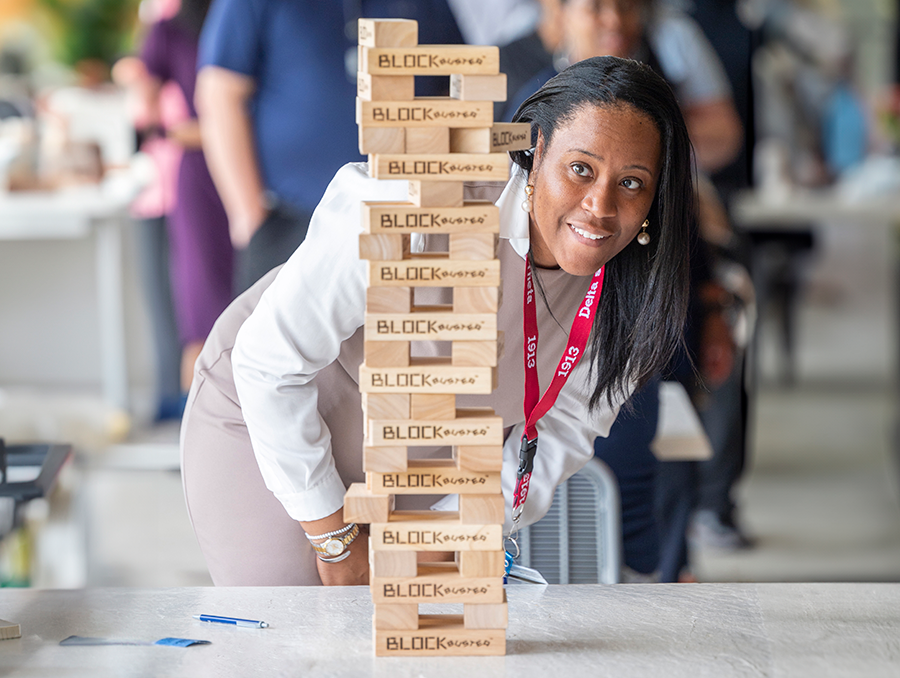 A woman looks at an oversized game of Jenga.