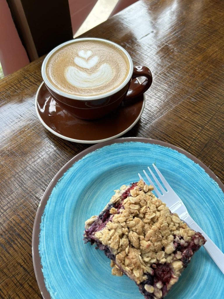 Photo of a coffee and a breakfast treat.