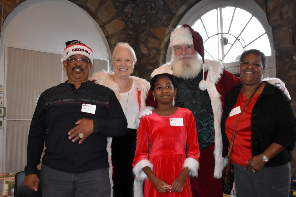 A young girl and her grandparents meets Santa and Mrs. Claus.