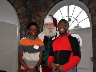 Two teenage boys pose with santa