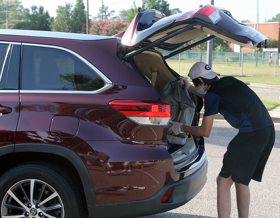 Man putting something in a car