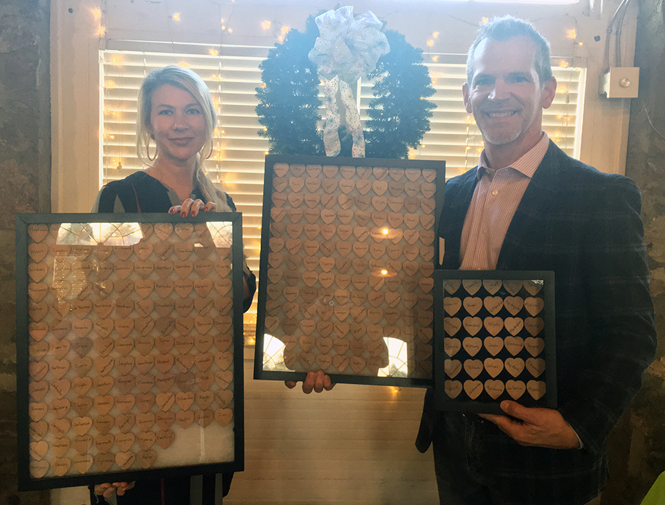 Woman and man holding frames