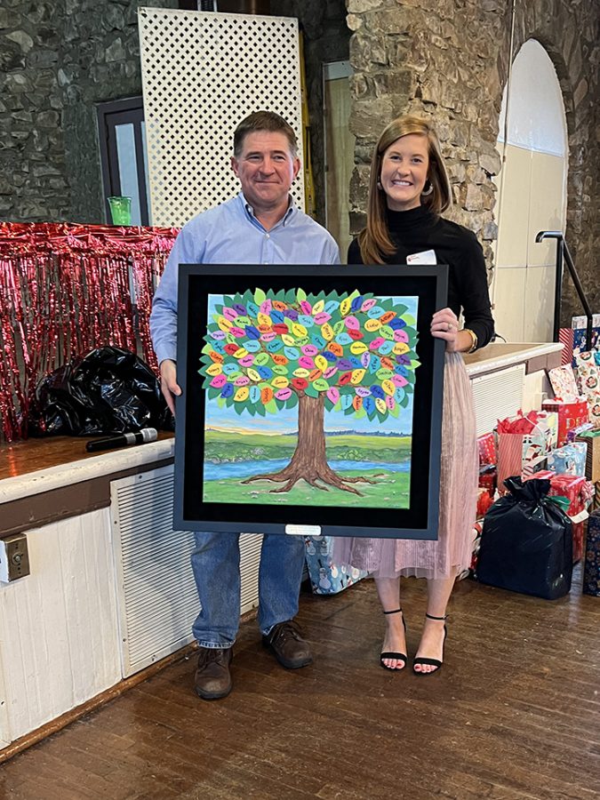 Man and woman holding a frame