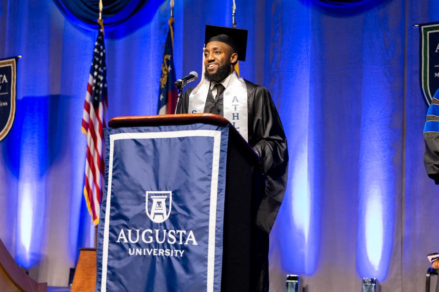 Man speaks at podium.