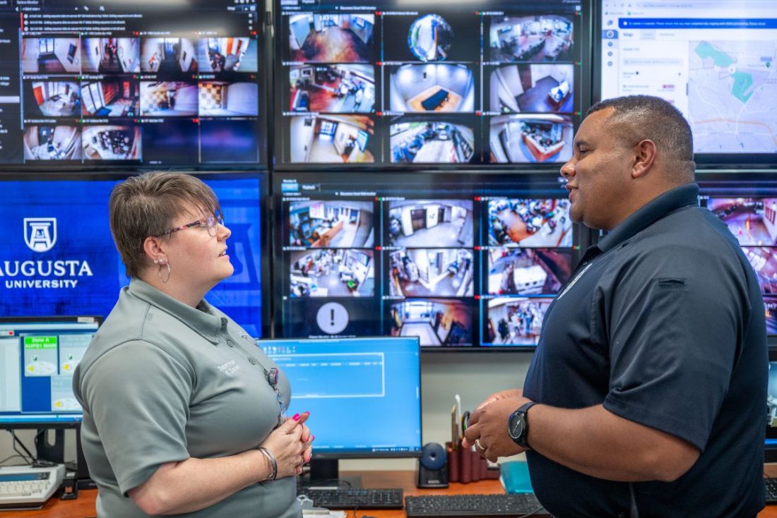 AUPD communications supervisor Robin Daniel, left, speaks with Bryant Leverett, captain of support services.