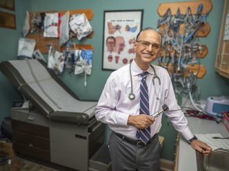 Man smiling in his office space