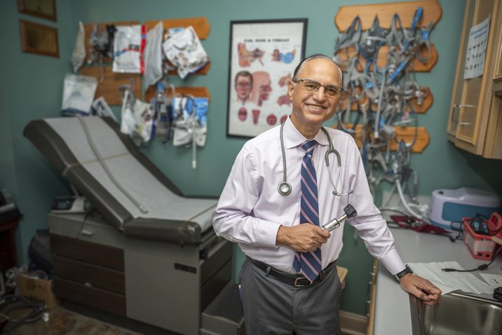 Man smiling in his office space