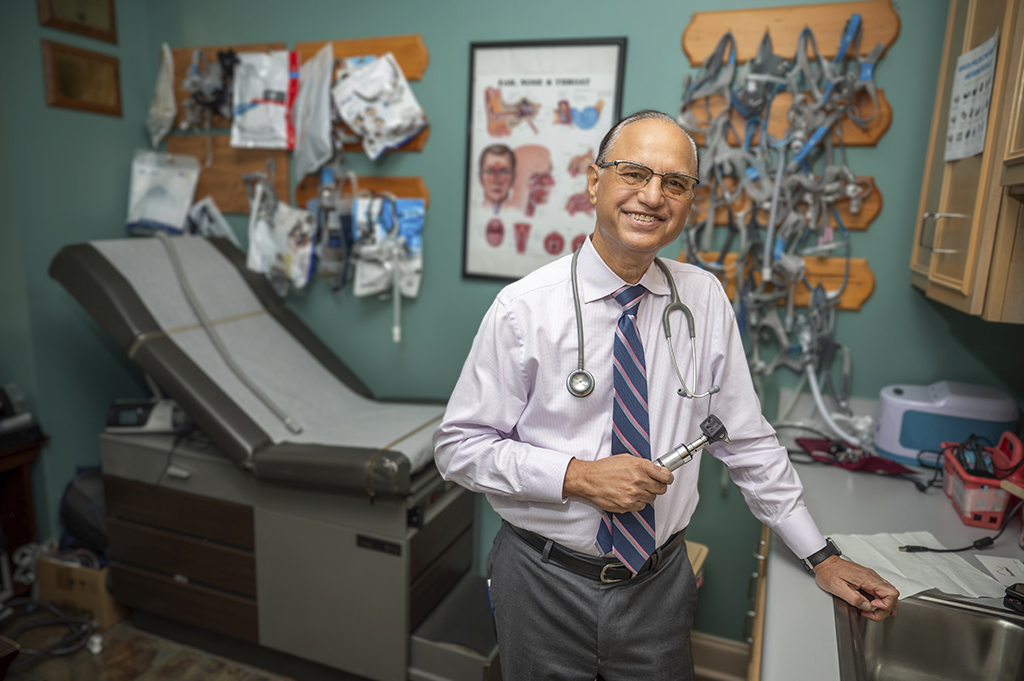 Man smiling in his office space