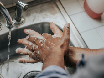 A person washed their hands with soap and water in a kitchen sink.