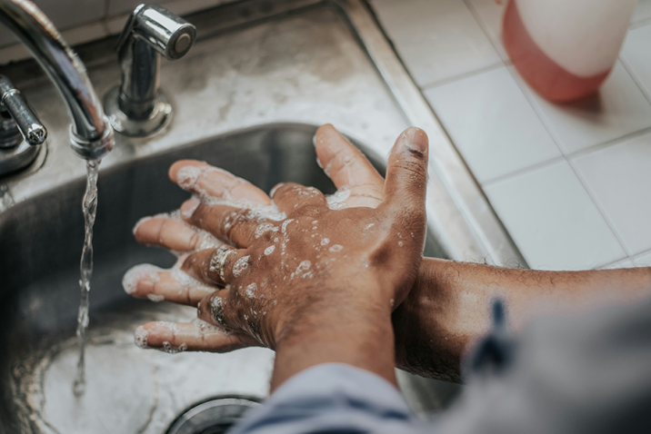 A person washed their hands with soap and water in a kitchen sink.