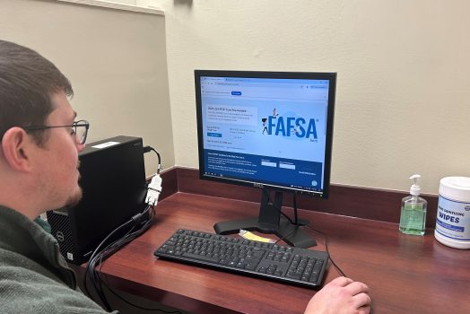 A man looks at a computer screen.