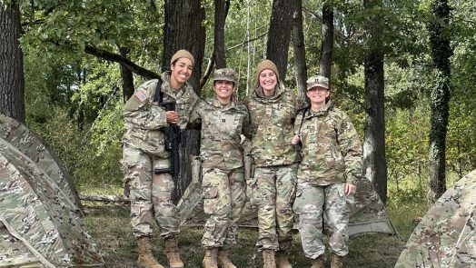 People in Army uniform posing for a photo