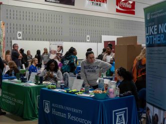 People are gathered around tables at an event.