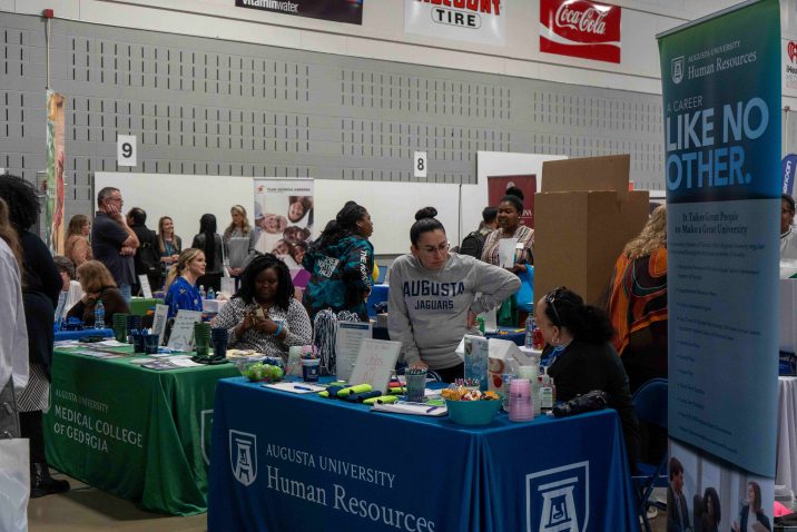 People are gathered around tables at an event.