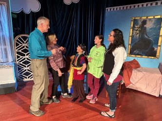 Man and woman talking with children and an adult woman