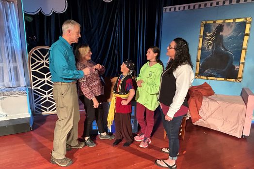 Man and woman talking with children and an adult woman