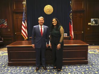 Intern standing with the Georgia governor