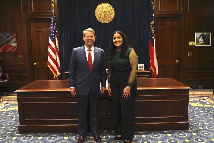 Intern standing with the Georgia governor