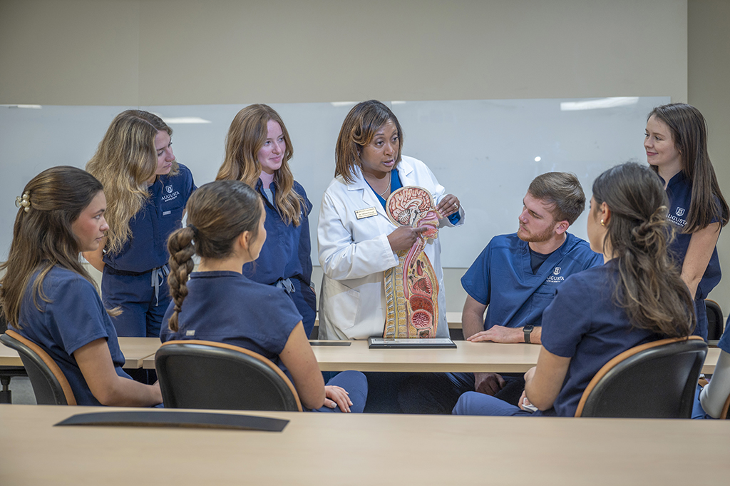 Female professor talking to students with a diagram