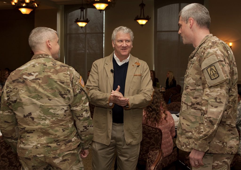 Man standing with Army soldiers