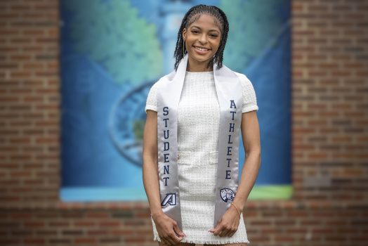 Woman smiling while wearing a sash