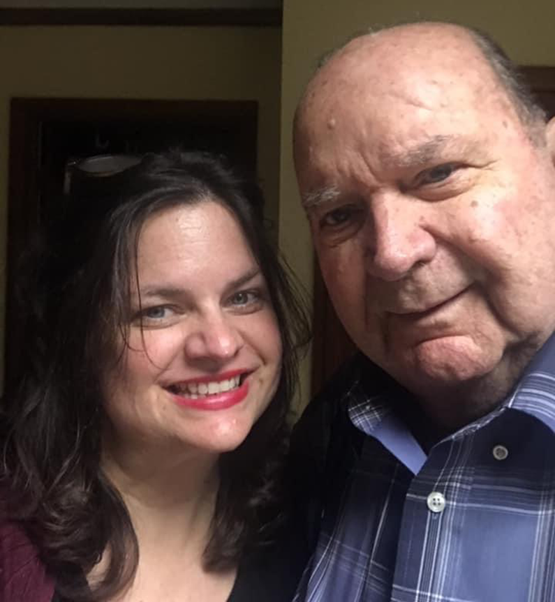 A smiling woman and a man take a selfie.
