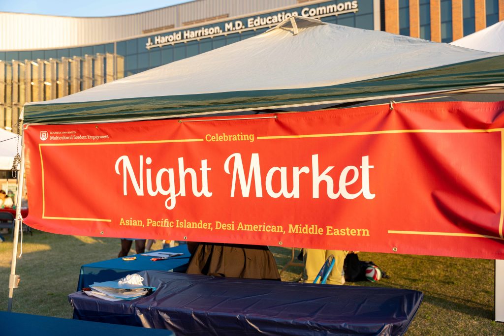 A banner at the top of a tent at an outdoor event.