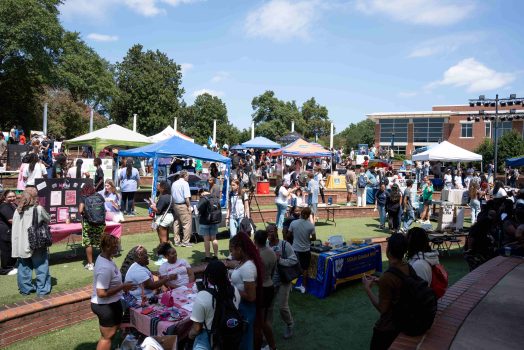 Many college organizations table at an outdoor event.