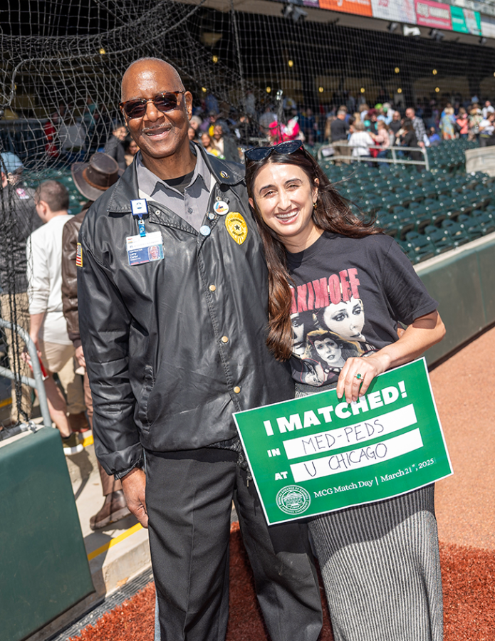 A security guard poses with a medical student holding a sign that reads 'I Matched! at MCG's Match Day.