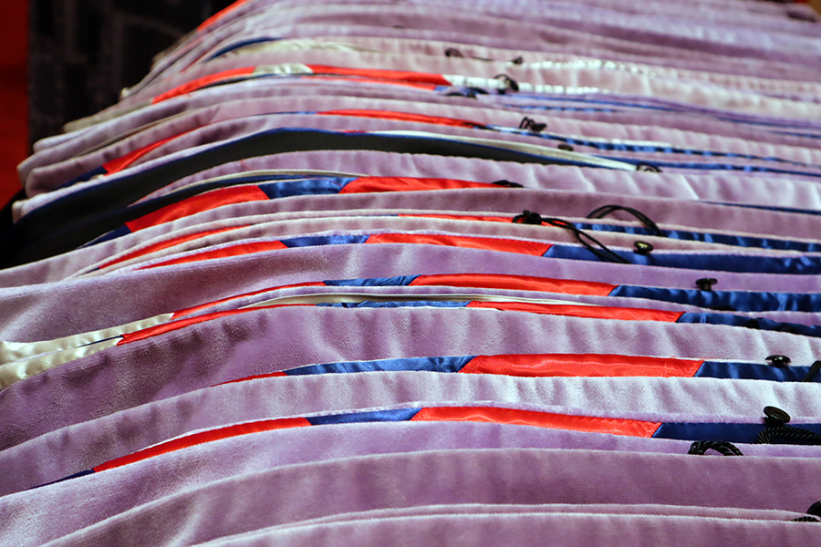 A row of special graduation hoods lay on a table.