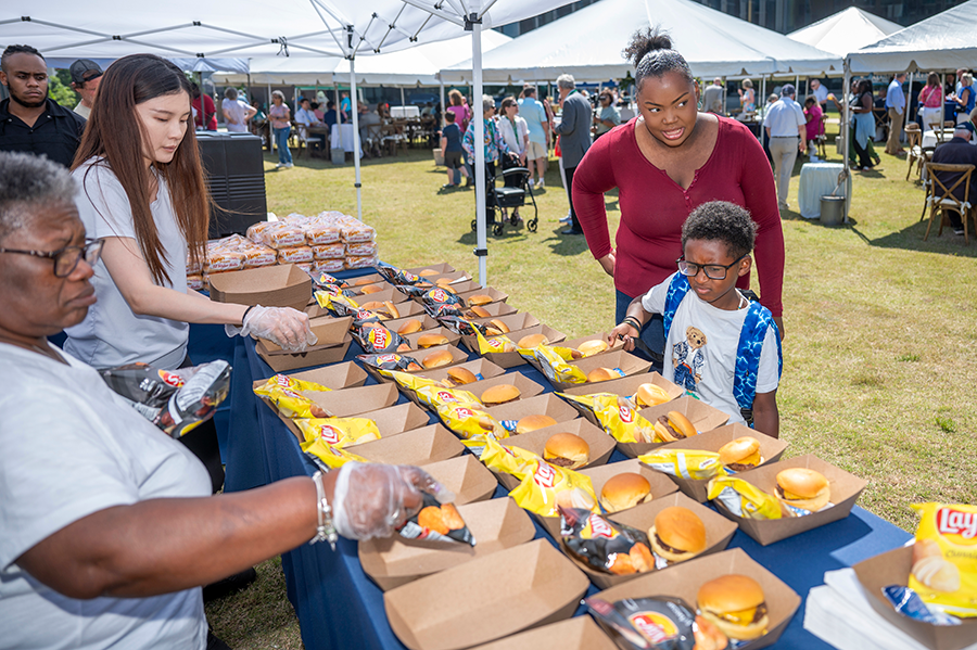 A young boy chooses a lunch during a big outdoor event.