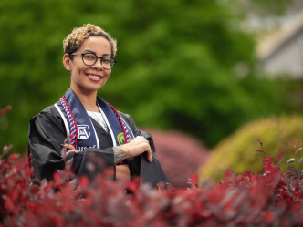 Tasha Barber smiles while posing on the Summerville Campus during Graduation Media Day.