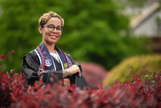 Tasha Barber smiles while posing on the Summerville Campus during Graduation Media Day.