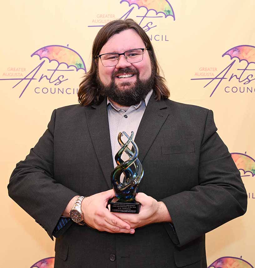 Man posing with award