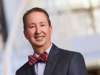 A man wearing a suit and a bowtie.