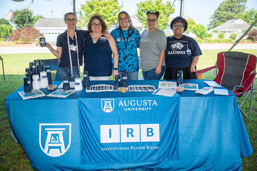 A group of women man a booth during a rural health fair.