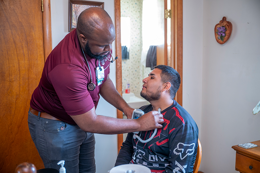 A healthcare worker conducts a test on a patient during a rural health clinic.