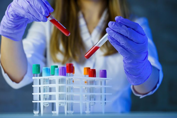 Scientist in lab with test tubes